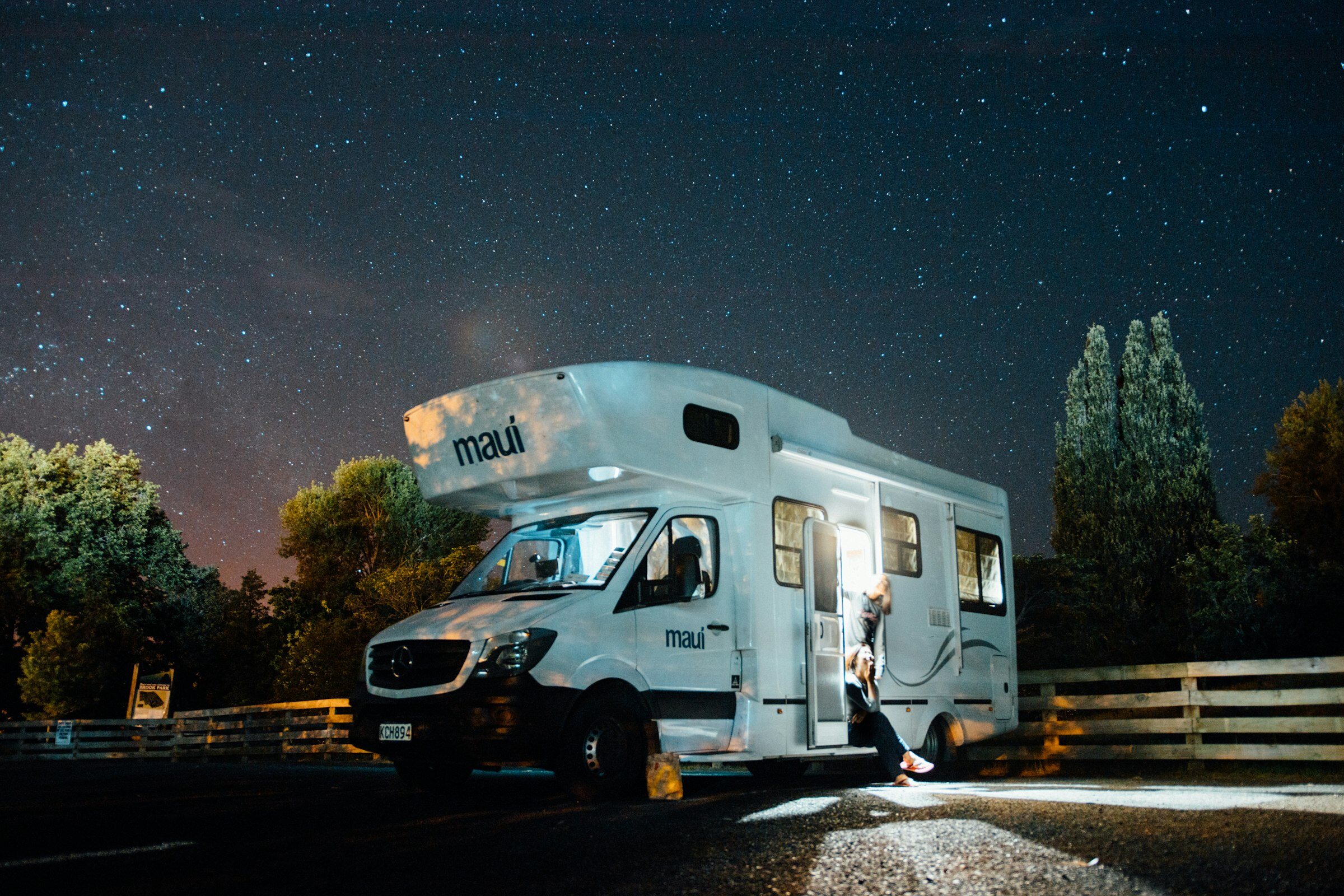 Class C motorhome parked under a night sky full of stars