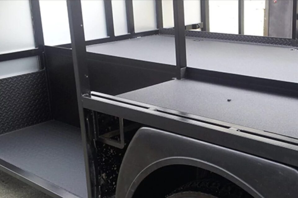 Trailer deck and rails protected with polyurea coating